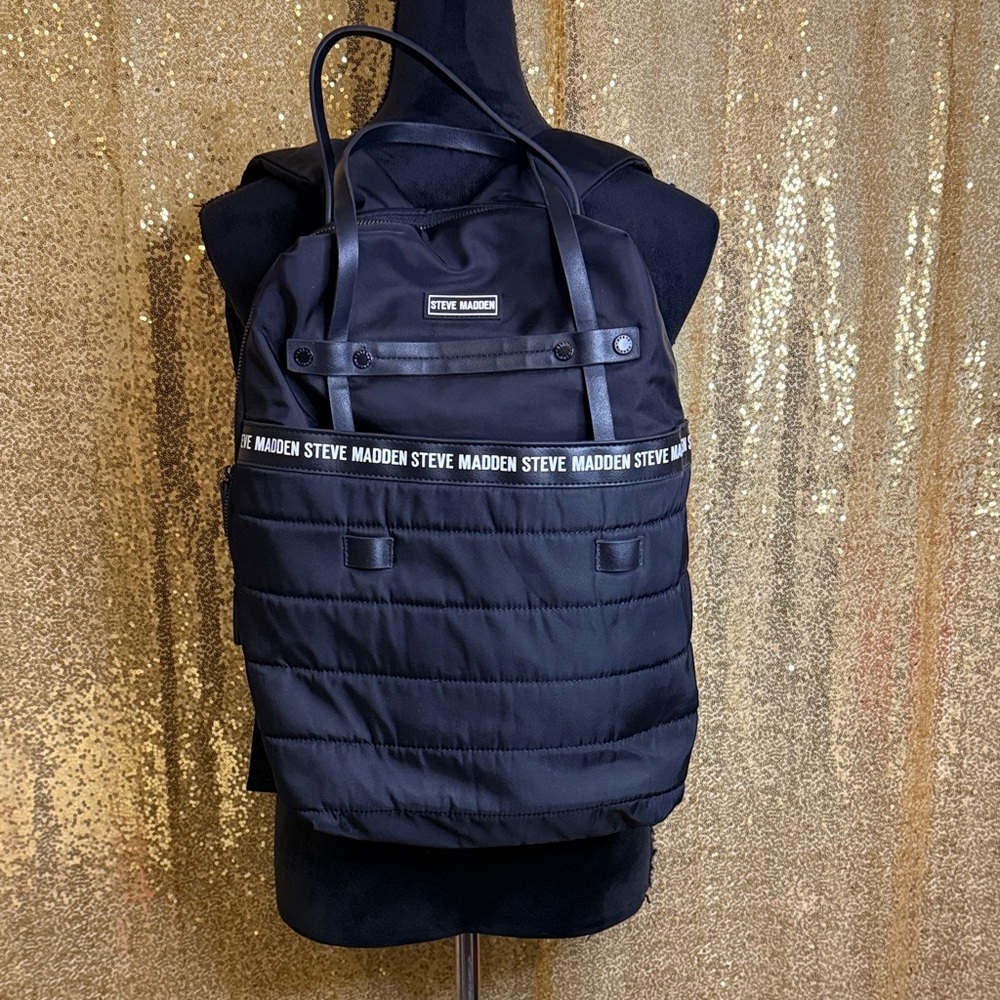 Steve Madden Bjodah Black Quilted Backpack with carry handles and branded strap
